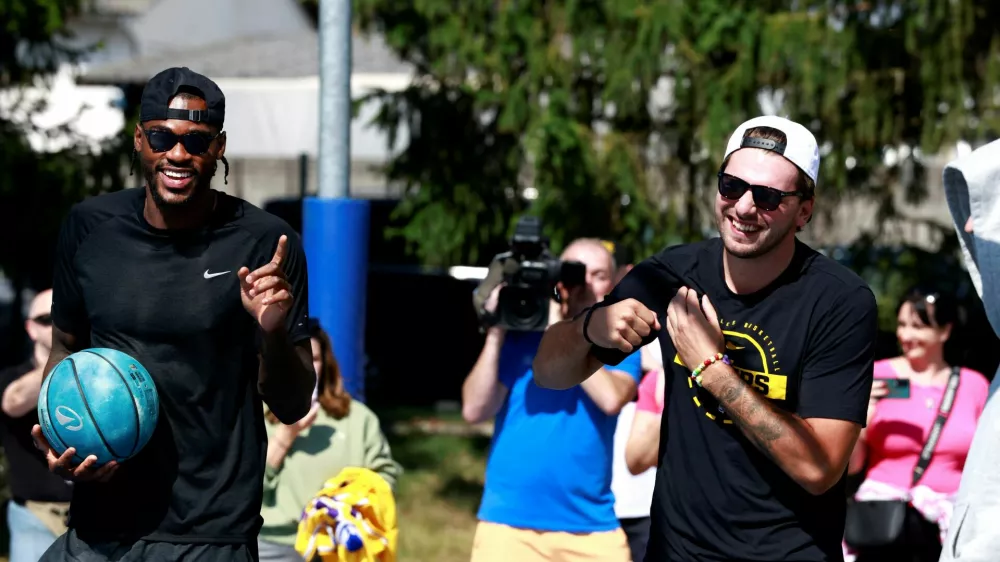 Basketball - NBA - Los Angeles Lakers visit to Ljubljana - Ljubljana, Slovenia - August 23, 2026 Los Angeles Lakers' Luka Doncic with Jarred Vanderbilt on the court where he played growing up in Ljubljana REUTERS/Borut Zivulovic