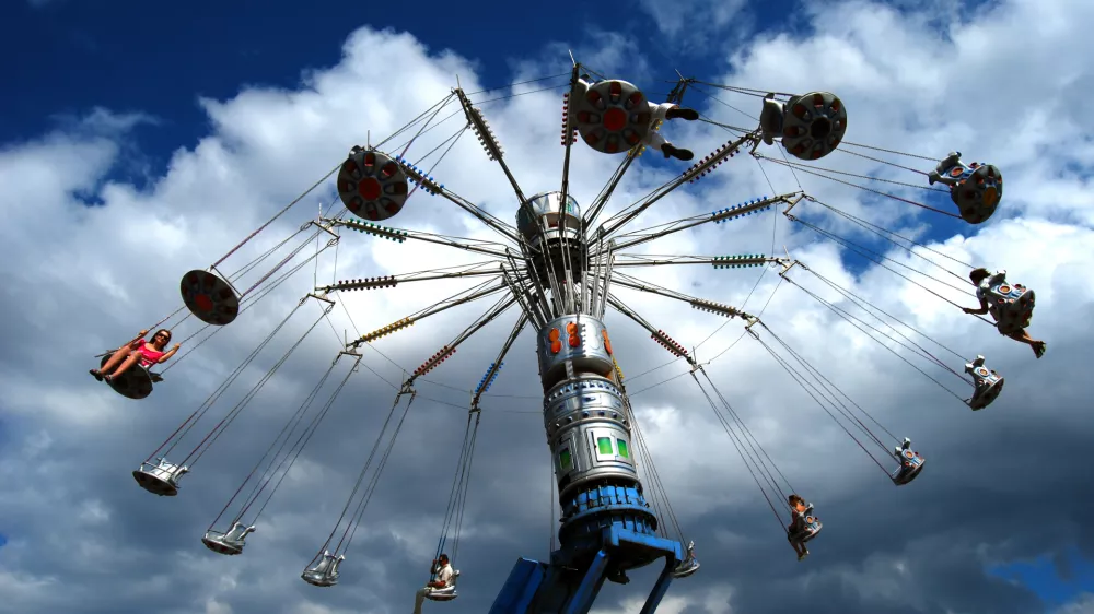 A rotating carousel on the blue sky