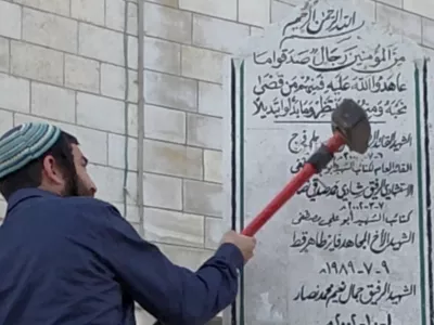 Tzvi Sukkot, a member of the Israeli Knesset, smashes a monument in Madama in the Israeli-occupied West Bank August 25, 2026, in this screen grab obtained from a handout video. Yosi Reiner, Tzvi Sukkot's office handout/Handout via REUTERS  THIS IMAGE HAS BEEN SUPPLIED BY A THIRD PARTY. VERIFICATION: -Monument, buildings, and road layout matched archive and satellite imagery -Date verified by statement from Tzvi Sukkot's office and Israeli military saying incident happened on Tuesday (August 25) -Israeli Military said soldiers were present during the incident as security for the member of Knesset who requested it earlier in the month for the tour of several areas -However, Israeli Military said the participants of the tour acted deceptively and began demolishing one of the monuments in Madama without authorization