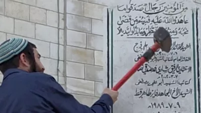 Tzvi Sukkot, a member of the Israeli Knesset, smashes a monument in Madama in the Israeli-occupied West Bank August 25, 2026, in this screen grab obtained from a handout video. Yosi Reiner, Tzvi Sukkot's office handout/Handout via REUTERS  THIS IMAGE HAS BEEN SUPPLIED BY A THIRD PARTY. VERIFICATION: -Monument, buildings, and road layout matched archive and satellite imagery -Date verified by statement from Tzvi Sukkot's office and Israeli military saying incident happened on Tuesday (August 25) -Israeli Military said soldiers were present during the incident as security for the member of Knesset who requested it earlier in the month for the tour of several areas -However, Israeli Military said the participants of the tour acted deceptively and began demolishing one of the monuments in Madama without authorization