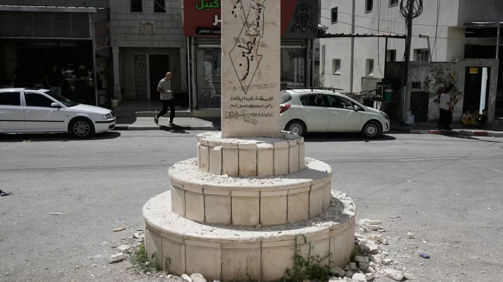 A damaged monument in the West Bank village of Madama, which bears the names of Palestinians killed in the Israeli-Palestinian conflict, including some identified by Israel as having been involved in attacks, after far-right Israeli lawmaker Zvi Sukkot of the Religious Zionism party smashed it, Tuesday, Aug. 25, 2026. (AP Photo/Majdi Mohammed)