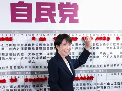 Sanae Takaichi, center, Japan's prime minister and president of the ruling Liberal Democratic Party (LDP), puts pins marking the names of candidates who won lower house elections, at the LDP headquarters Sunday, Feb. 8, 2026 in Tokyo, (Kim Kyung-Hoon/Pool Photo via AP)