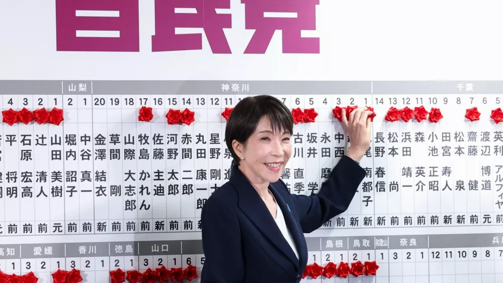 Sanae Takaichi, center, Japan's prime minister and president of the ruling Liberal Democratic Party (LDP), puts pins marking the names of candidates who won lower house elections, at the LDP headquarters Sunday, Feb. 8, 2026 in Tokyo, (Kim Kyung-Hoon/Pool Photo via AP)