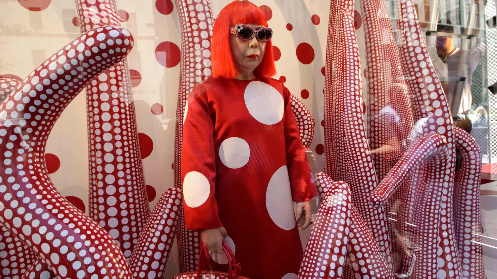 FILE - A wax model of Japanese artist Yayoi Kusama is displayed in the windows of Louis Vuitton's flagship Fifth Avenue store in New York, Tuesday, July 10, 2012. (AP Photo/Kathy Willens, File)