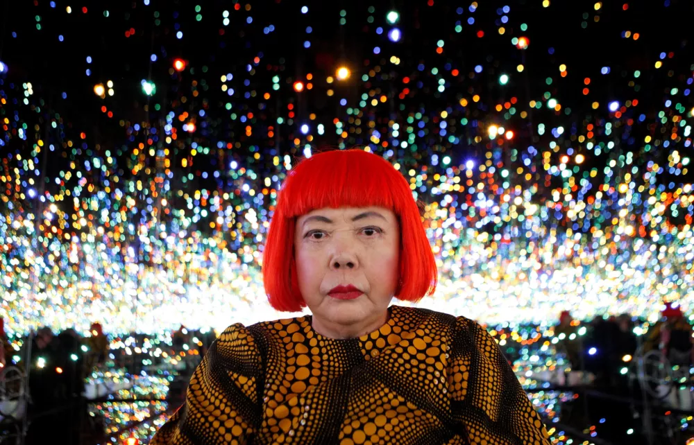 FILE PHOTO: Japanese artist Yayoi Kusama poses for a photograph inside her Infinity Mirrored Room installation titled "The Souls of Millions of Light Years Away" during a media preview of her new exhibition at the David Zwirner gallery in New York, U.S., November 7, 2013. REUTERS/Mike Segar/File Photo   TPX IMAGES OF THE DAY