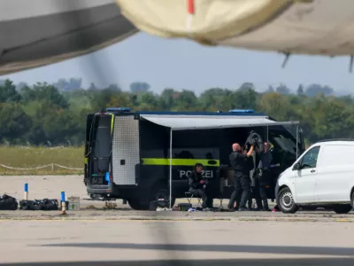 Police officers work in the vicinity of an Antonov cargo plane, near which a drone was found, at Leipzig/Halle Airport in Schkeuditz, Germany, August 5, 2026, after the police said explosives experts examined a drone near a runway, and after a DHL cargo aircraft hit an unknown object as it was climbing away from the airport overnight, prompting an unscheduled landing in Hanover, according to a source familiar with the incident. REUTERS/Axel Schmidt