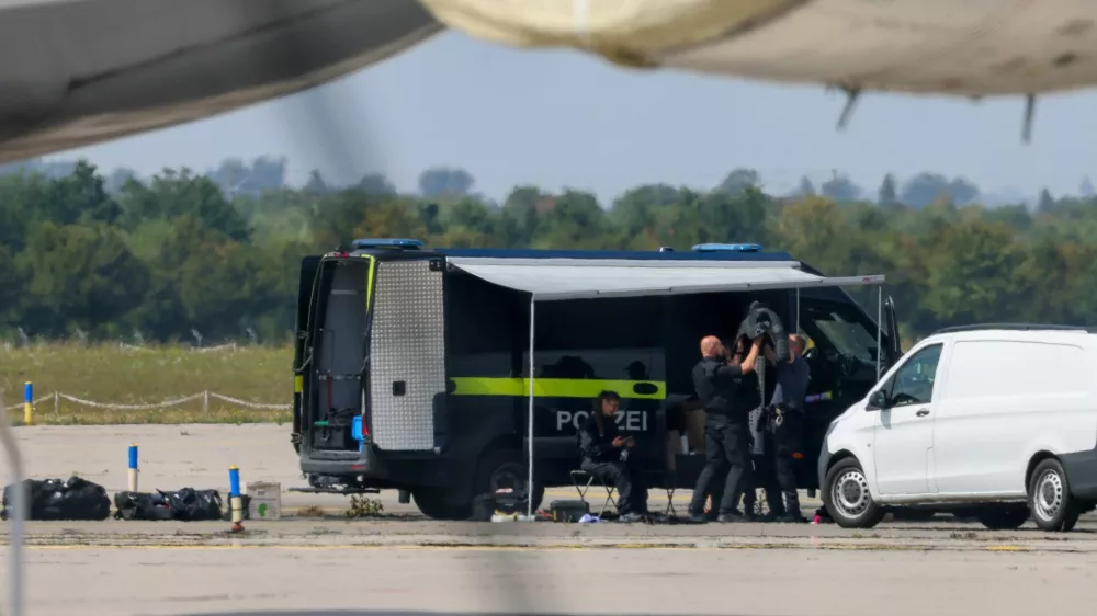 Police officers work in the vicinity of an Antonov cargo plane, near which a drone was found, at Leipzig/Halle Airport in Schkeuditz, Germany, August 5, 2026, after the police said explosives experts examined a drone near a runway, and after a DHL cargo aircraft hit an unknown object as it was climbing away from the airport overnight, prompting an unscheduled landing in Hanover, according to a source familiar with the incident. REUTERS/Axel Schmidt