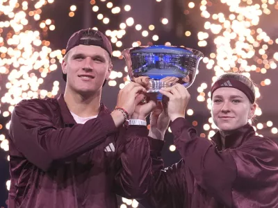 Jakub Mensik, left, and Karolina Muchova, both of the Czech Republic, pose with the trophy after defeating Belinda Bencic, of Switzerland, and Flavio Cobolli, of Italy, in the mixed doubles final match at the U.S. Open tennis championships Thursday, Aug. 27, 2026, in New York. (AP Photo/Frank Franklin II)