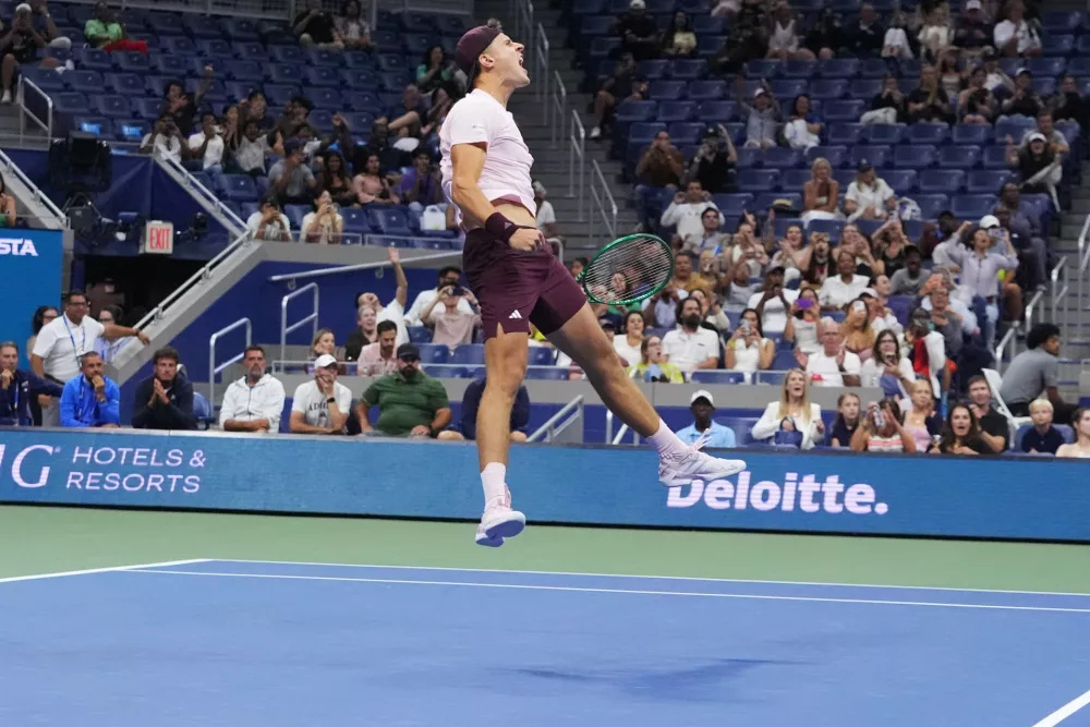 Jakub Mensik, of the Czech Republic, celebrates after he and Karolina Muchova, of the Czech Republic, defeated Belinda Bencic, of Switzerland, and Flavio Cobolli, of Italy, in the mixed doubles final match at the U.S. Open tennis championships Wednesday, Aug. 26, 2026, in New York. (AP Photo/Frank Franklin II)