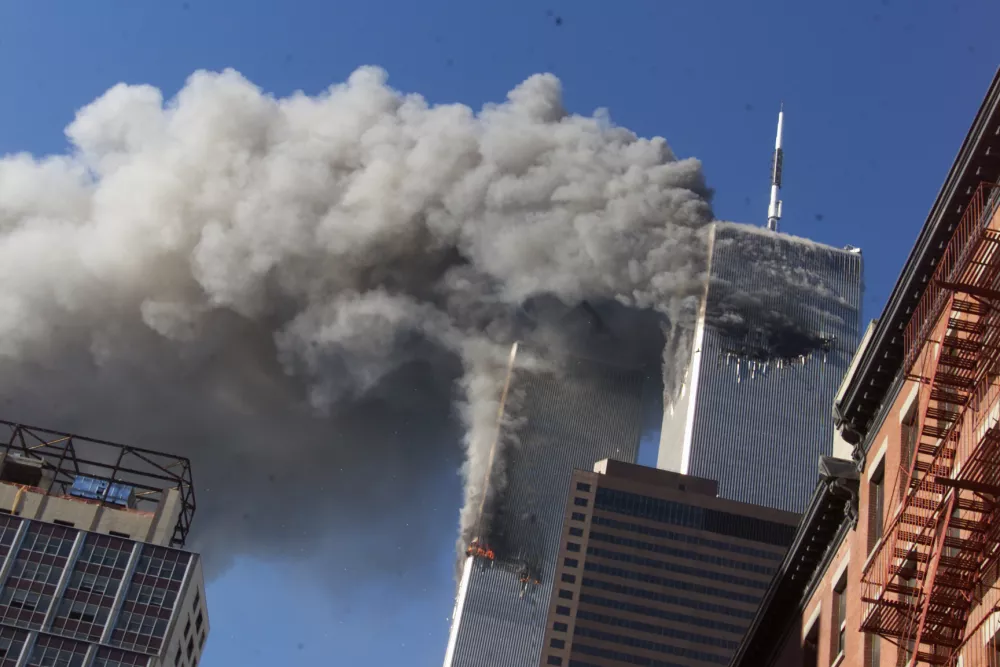 FILE - In this Sept. 11, 2001, file photo, smoke rises from the burning twin towers of the World Trade Center after hijacked planes crashed into the towers in New York City. Sept. 11 victims&acirc;&euro;&trade; relatives are greeting the news of President Donald Trump&acirc;&euro;&trade;s now-canceled plan for secret talks with Afghanistan&acirc;&euro;&trade;s Taliban insurgents with mixed feelings. (AP Photo/Richard Drew, File)