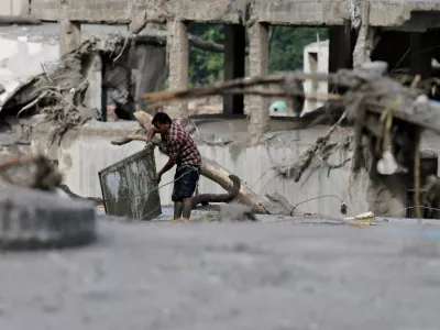 A man salvages his belongings from mud following devastating floods, in Trishuli, Nuwakot district, Nepal, August 27, 2026. REUTERS/Navesh Chitrakar
