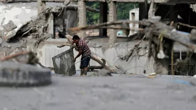 A man salvages his belongings from mud following devastating floods, in Trishuli, Nuwakot district, Nepal, August 27, 2026. REUTERS/Navesh Chitrakar