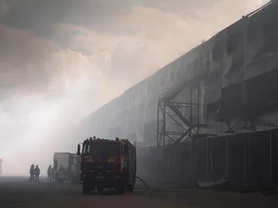 Smoke rises above warehouse stores after a Russian air attack in Kyiv, Ukraine, Thursday, Aug. 27, 2026. (AP Photo/Efrem Lukatsky)