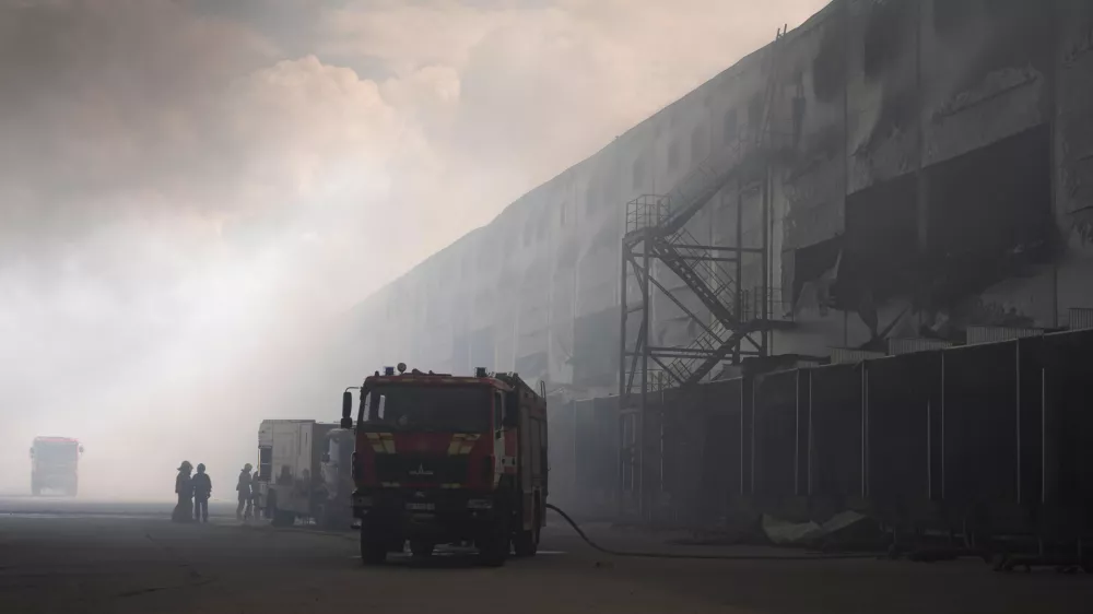 Smoke rises above warehouse stores after a Russian air attack in Kyiv, Ukraine, Thursday, Aug. 27, 2026. (AP Photo/Efrem Lukatsky)