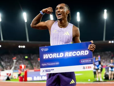Brazil's Alison dos Santos celebrates winning the men's 400-meter hurdles, setting a new world record, at the Diamond League athletics meeting, Thursday, Aug. 27, 2026, in Zurich, Switzerland. (Jean-Christophe Bott/Keystone via AP)
