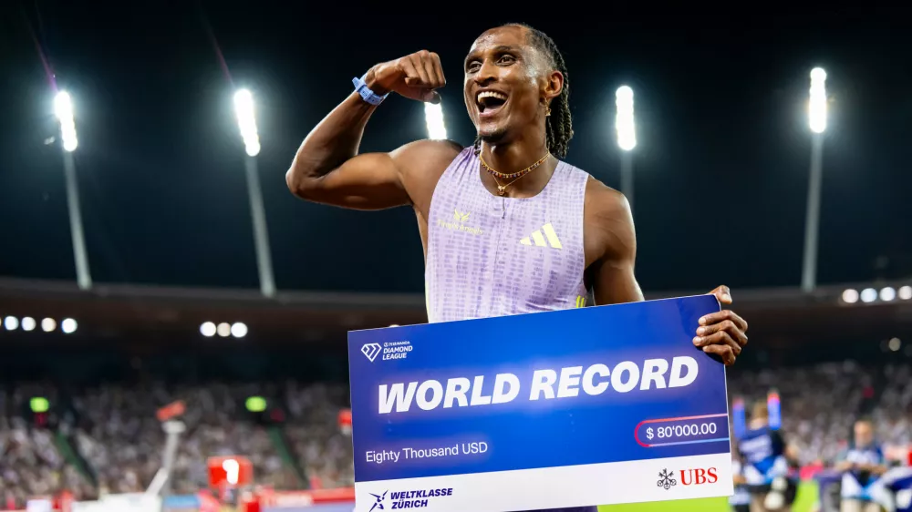 Brazil's Alison dos Santos celebrates winning the men's 400-meter hurdles, setting a new world record, at the Diamond League athletics meeting, Thursday, Aug. 27, 2026, in Zurich, Switzerland. (Jean-Christophe Bott/Keystone via AP)