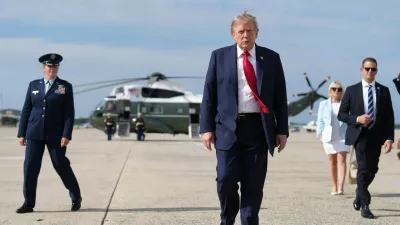 FILE - President Donald Trump, center, walks from Marine One to board Air Force One, Aug. 21, 2026, at Joint Base Andrews, Md., en route to South Carolina. (AP Photo/Jacquelyn Martin, File)