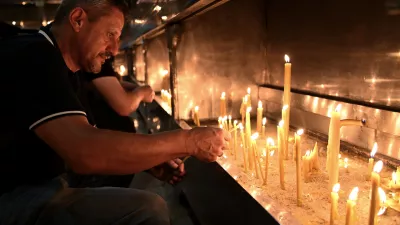 People light candles for former Bosnian Serb wartime general Ratko Mladic, in front of church in the Bosnian town of Banja Luka, 240 kms. (140 miles) northwest of Sarajevo, Thursday, August. 27, 2026. (AP Photo/Radivoje Pavicic)