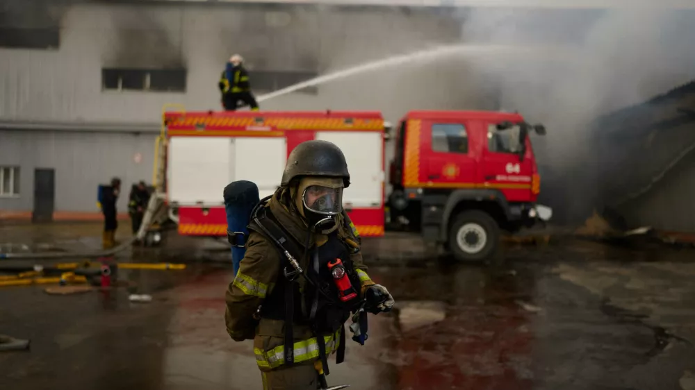 Firefighters try to extinguish a fire at a destroyed warehouse after Russian drone attacks on the outskirts of Kyiv, Ukraine, Friday, Aug. 28, 2026. (AP Photo/Francisco Seco)