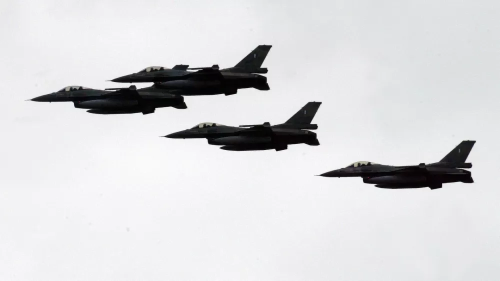 ** FILE ** Greek F-16 fighter jets participate in Independence Day celebrations in Athens on Saturday, March 25, 2006. A Greek F-16 fighter jet and a Turkish warplane collided as they shadowed each other Tuesday, and crashed near the Greek island of Karpathos in the Aegean Sea on Tuesday, May 23, 2006. (AP Photo/Thanassis Stavrakis, File)