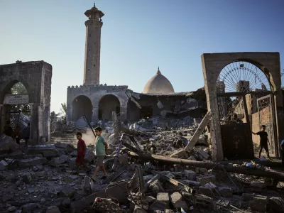 Palestinians inspect the Abu Salim Mosque a day after it was hit by an Israeli airstrike, in Deir al-Balah, central Gaza Strip, Tuesday, Aug. 25, 2026. (AP Photo/Abdel Kareem Hana)