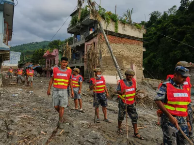 Workers clear debris in the aftermath of a flash flood in the Devighat area of Nuwakot district in Nepal, Friday, Aug. 28, 2026. (AP Photo/Rajesh Kumar Singh)