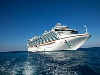 "Eastern Caribbean Sea - February 8, 2010: A luxury cruise ship anchors in the water as passengers are taken by ferry to the local tropical island for a day of sun and fun."