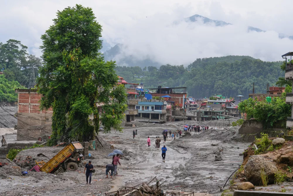 Residents return to their houses to assess the damage following flash flooding in Nuwakot district in Nepal, Saturday, Aug. 29, 2026. (AP Photo/Rajesh Kumar Singh)