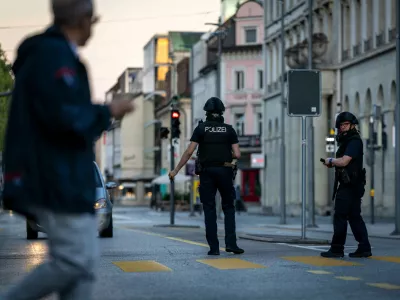 Police officers patrol a street in downtown Aarau, Switzerland Sunday, Aug. 30, 2026, following a shooting at a rave. (Michael Buholzer/Keystone via AP)