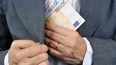 man putting money in his pocket