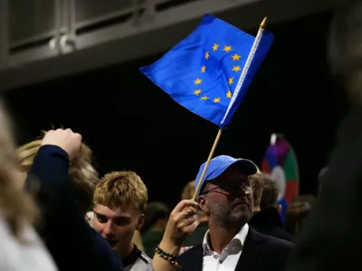 A supporter waves a European Union flag during an election-night gathering for the yes in Reykjavik, Iceland, Sunday, Aug. 30, 2026. (AP Photo/Marco Di Marco)