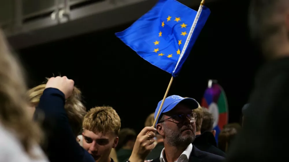 A supporter waves a European Union flag during an election-night gathering for the yes in Reykjavik, Iceland, Sunday, Aug. 30, 2026. (AP Photo/Marco Di Marco)