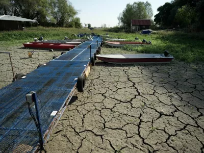 Boats sit on dry ground as water levels have dropped on the Danube River in Petrovaradin, Serbia, Tuesday, Aug. 25, 2026. (AP Photo/Darko Vojinovic)