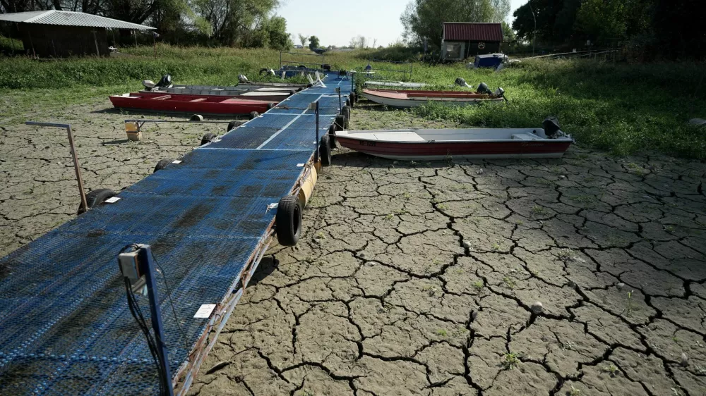 Boats sit on dry ground as water levels have dropped on the Danube River in Petrovaradin, Serbia, Tuesday, Aug. 25, 2026. (AP Photo/Darko Vojinovic)