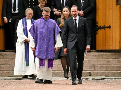 Norway's King Haakon, Crown Princess Ingrid Alexandra walk with priests Ida Buen Hanevold and Oyvind Stabrun after attending a memorial service for the late King Harald, in Asker, Norway, August 30, 2026. REUTERS/Dylan Martinez