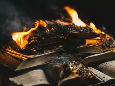 Open book is on fire, pages are engulfed in flames. Concept of censorship, prohibition of freedom information, 451 fahrenheit, old literature in paper format is no longer in demand. High photo