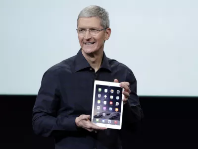 Apple CEO Tim Cook introduces the new Apple iPad Air 2 during an event at Apple headquarters on Thursday, Oct. 16, 2014 in Cupertino, Calif. (AP Photo/Marcio Jose Sanchez)