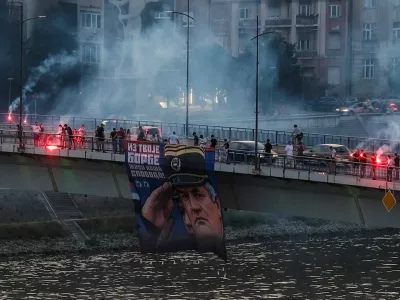 Supporters of the deceased Bosnian Serb general Ratko Mladic hold his picture and light flares on the Varadinski Bridge In Novi Sad Serbia, Serbia, August 27, 2026. REUTERS/Stefan Stojanovic