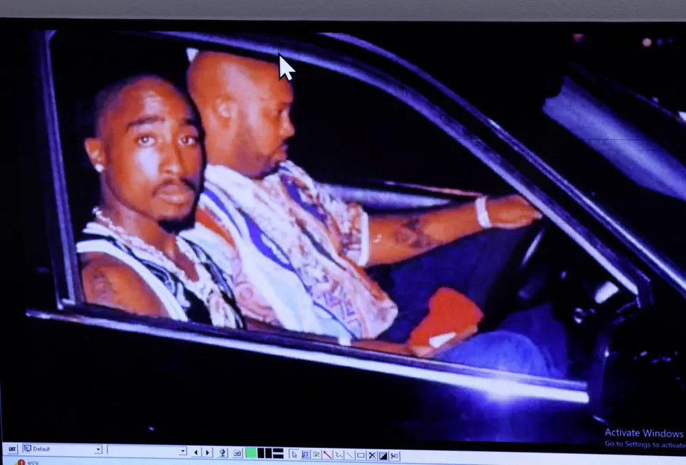 FILE PHOTO: A photograph of rapper Tupac Shakur and Suge Knight, right, taken by Leonard Jefferson, just minutes before the fatal shooting, is displayed during the murder trial of Duane Davis, not photographed, related to the 1996 killing of the rapper, in Clark County District Court at the Regional Justice Center on Friday, Aug. 21, 2026, in Las Vegas. Bizuayehu Tesfaye/Pool via REUTERS/File Photo