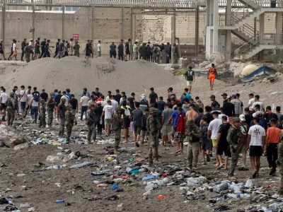 FILE PHOTO: People walk towards the border with Morocco leaving Spain, amid mass crossings of migrants on foot and by sea from Morocco into Spanish territory, in Ceuta, Spain, July 31, 2026. REUTERS/Jon Nazca/File Photo