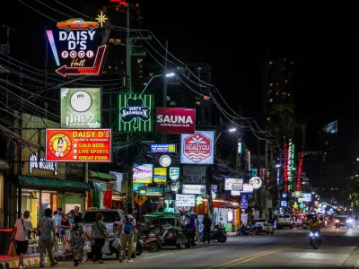 People walk along a street lined with bars and entertainment venues at Jomtien Beach, in Pattaya City, Thailand, June 29, 2026. REUTERS/Chalinee Thirasupa