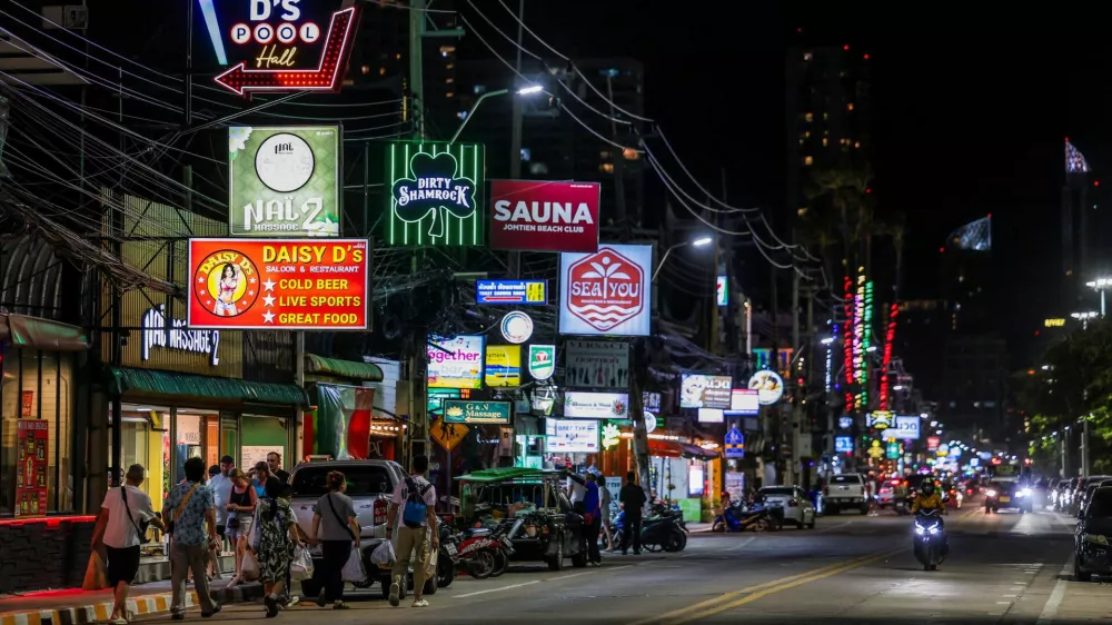 People walk along a street lined with bars and entertainment venues at Jomtien Beach, in Pattaya City, Thailand, June 29, 2026. REUTERS/Chalinee Thirasupa