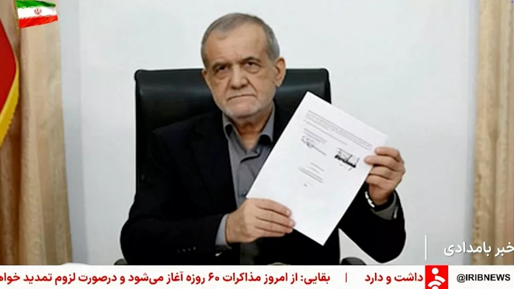 A screen grab shows Iran's President Masoud Pezeshkian holding a signed memorandum with U.S. President Donald Trump, in Tehran, Iran, June 18, 2026, taken from a video. Pool via WANA/Reuters TV/Handout via REUTERS  THIS IMAGE HAS BEEN SUPPLIED BY A THIRD PARTY. ISRAEL OUT. NO COMMERCIAL OR EDITORIAL SALES IN ISRAEL. NO USE BBC PERSIAN. NO USE VOA PERSIAN. NO USE MANOTO. NO USE IRAN INTERNATIONAL. NO USE RADIO FARDA, NO USE ISRAEL. FOR REUTERS CUSTOMERS ONLY. OVERLAYS FROM SOURCE.   TPX IMAGES OF THE DAY
