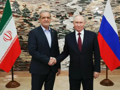 Russian President Vladimir Putin, right, and Iranian President Masoud Pezeshkian pose for a photo during their meeting on the sidelines of the Shanghai Cooperation Organization (SCO), in Bishkek, Kyrgyzstan, on Tuesday, Sept. 1, 2026. (Vyacheslav Prokofyev, Sputnik, Kremlin Pool Photo via AP)