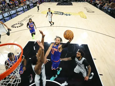 FILE PHOTO: Jun 13, 2026; San Antonio, Texas, USA; New York Knicks guard Jalen Brunson (11) drives to the basket as San Antonio Spurs guard De'aaron Fox (4) defends during game five of the 2026 NBA Finals at Frost Bank Center. Mandatory Credit: Geoff Burke-Imagn Images/File Photo