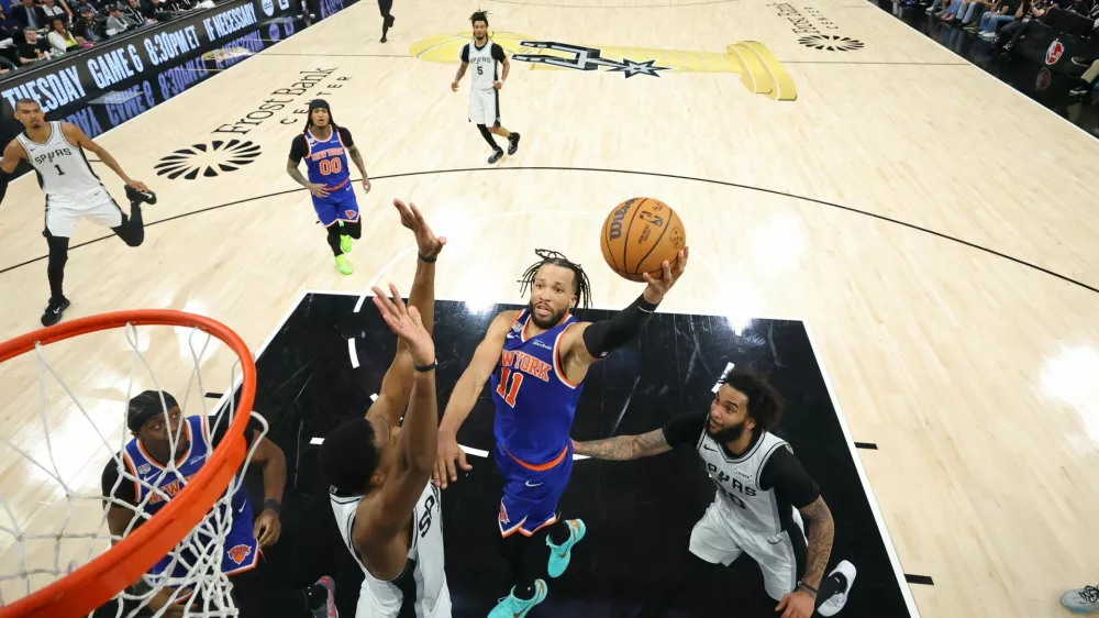FILE PHOTO: Jun 13, 2026; San Antonio, Texas, USA; New York Knicks guard Jalen Brunson (11) drives to the basket as San Antonio Spurs guard De'aaron Fox (4) defends during game five of the 2026 NBA Finals at Frost Bank Center. Mandatory Credit: Geoff Burke-Imagn Images/File Photo