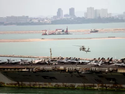 A helicopter lands on the U.S. Navy aircraft carrier USS Abraham Lincoln after it arrived at the port in Laem Chabang, Chonburi, Thailand, Wednesday, Sept. 2, 2026. (AP Photo/Sakchai Lalit)