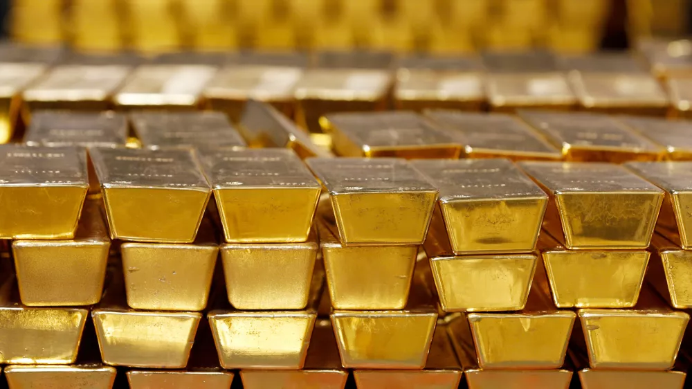 FILE - Gold bars are stacked in a vault at the United States Mint on July 22, 2014, in West Point, N.Y. (AP Photo/Mike Groll, File)