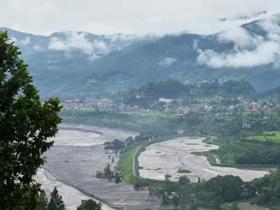 Structures partially submerged in mud brought in by flash floods stand at the banks of the Trishuli river in Nepal's Nuwakot district, Thursday, Sept. 3, 2026. (AP Photo/Rajesh Kumar Singh)
