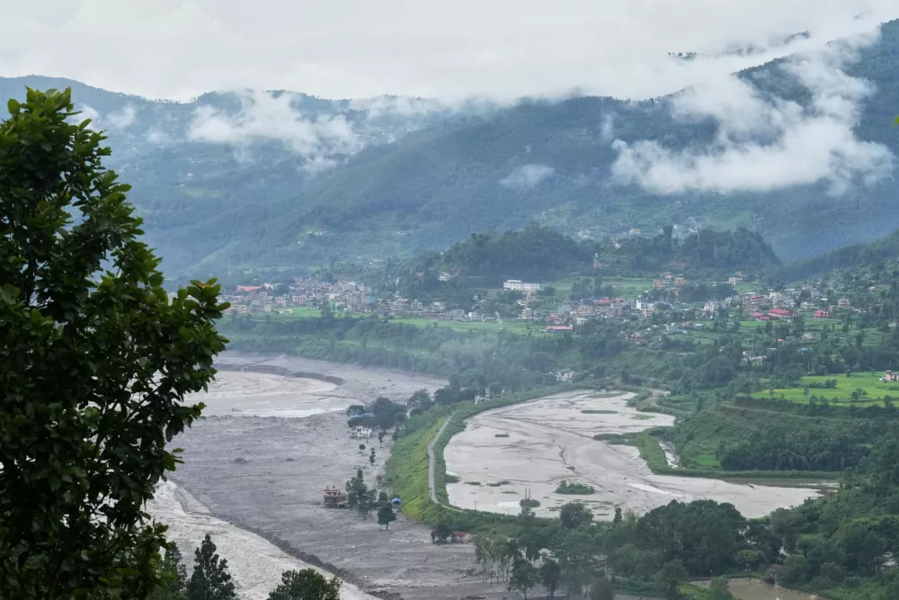 Structures partially submerged in mud brought in by flash floods stand at the banks of the Trishuli river in Nepal's Nuwakot district, Thursday, Sept. 3, 2026. (AP Photo/Rajesh Kumar Singh)
